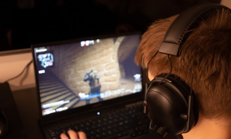 Boy playing the game on gaming laptop