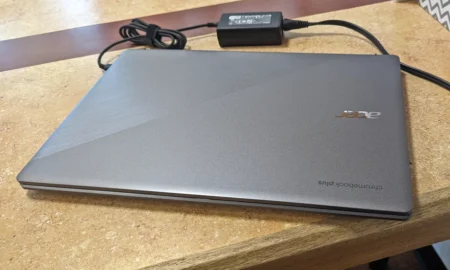 Acer Chromebook closed with power adapter connected.