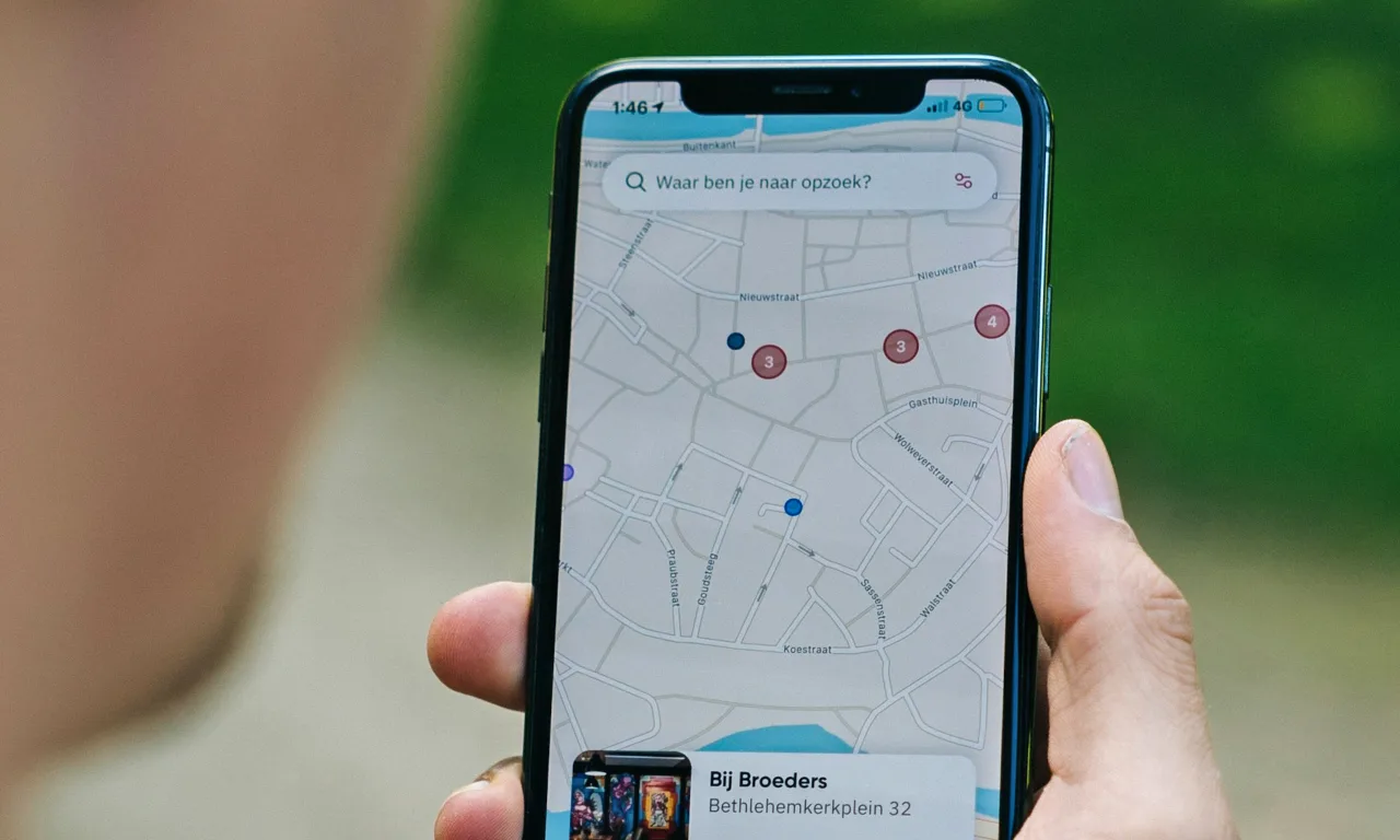 IPhone in person hands with Google Maps open 