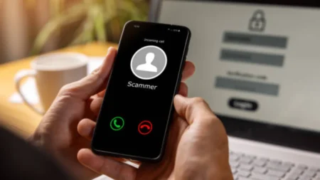 Beware, Scammers are Calling to ‘Fix’ Your New Phone Delivery, Don’t Fall for It A person holding a newly unboxed smartphone while receiving an incoming call from a spoofed carrier number.