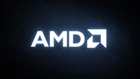 AMD Brings XDNA 2 NPU to Ryzen AI Pro 400 Desktop Processors — Your Next Work PC Might Actually Think for Itself Glowing white AMD logo displayed on a digital screen against a dark, textured background.