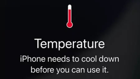 Why is My iPhone Getting Hot? Reasons & How to Fix Phone Overheating iPhone showing temperature warning screen with red thermometer icon.