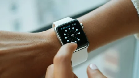 How to Unpair or Reset Apple Watch: The Right Way to Do Unpair or Reset Apple Watch - Person wearing aluminium case Apple Watch with white sports band.