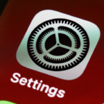 Close-up of the iOS Settings app icon on a smartphone screen