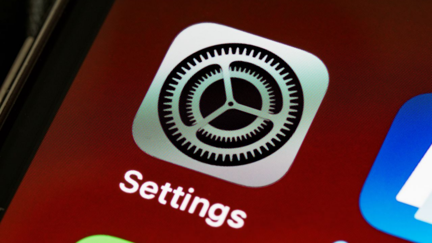 Close-up of the iOS Settings app icon on a smartphone screen